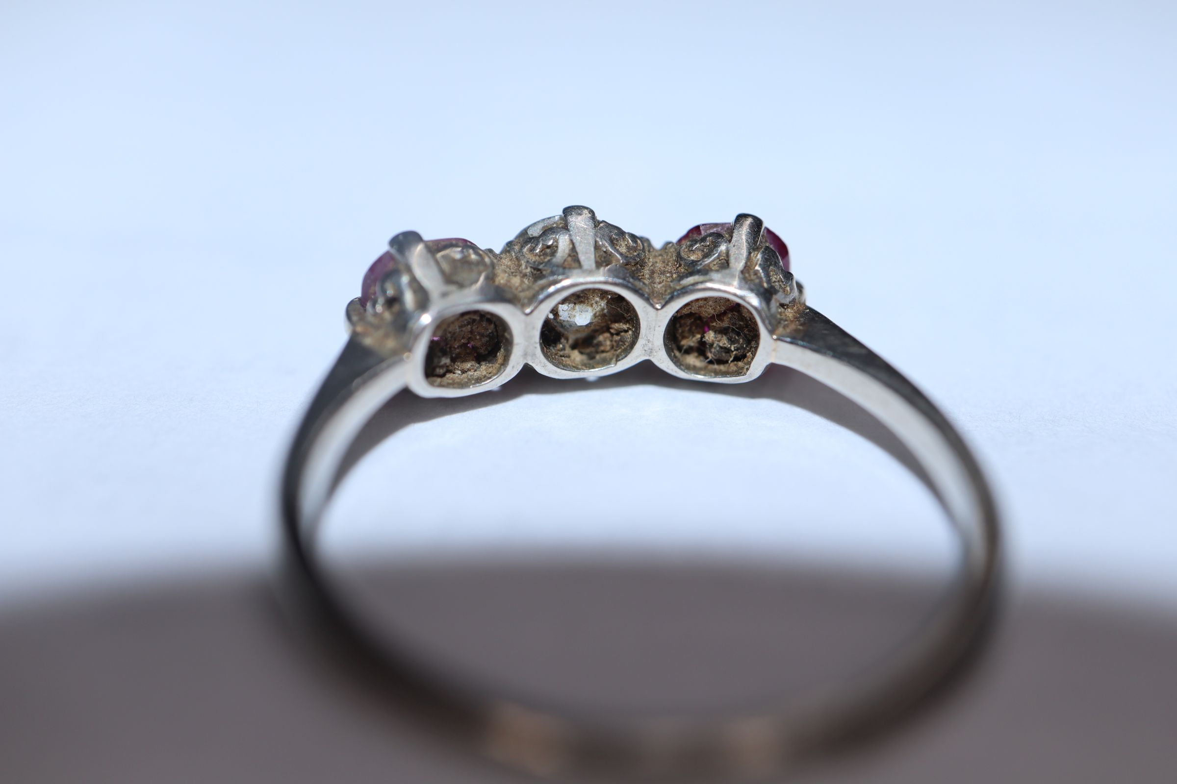 A white metal, ruby and diamond three stone ring, (shank cut). - Image 3 of 7