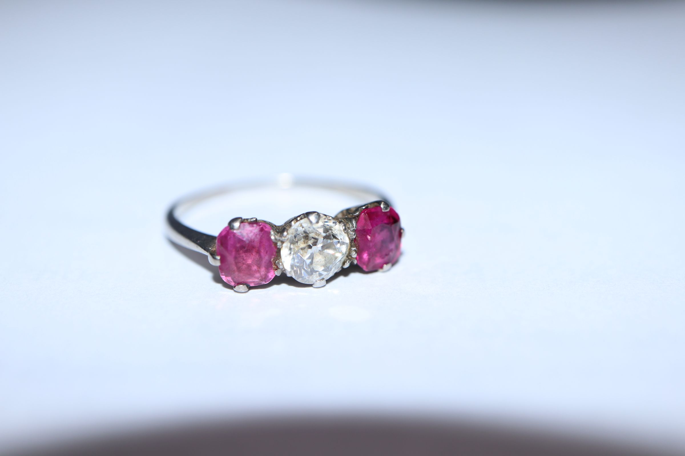 A white metal, ruby and diamond three stone ring, (shank cut). - Image 4 of 7