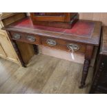 A Shoolbred walnut writing table W.106cm