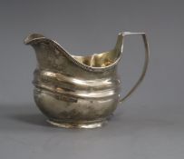 A George III silver cream jug with reeded border, London, 1808, 9.2cm.