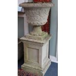 A pair of reconstituted stone campana shaped gardens urns, on plinth H.134cm