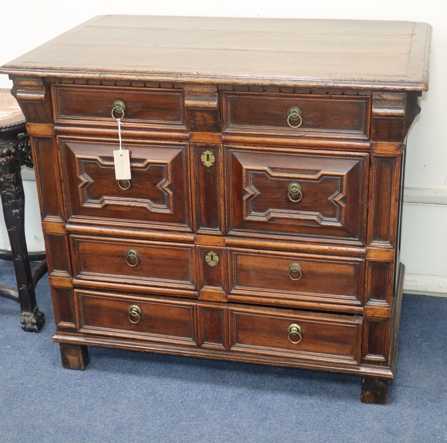 An early 18th century oak geometric moulded four drawer chest W.96cm