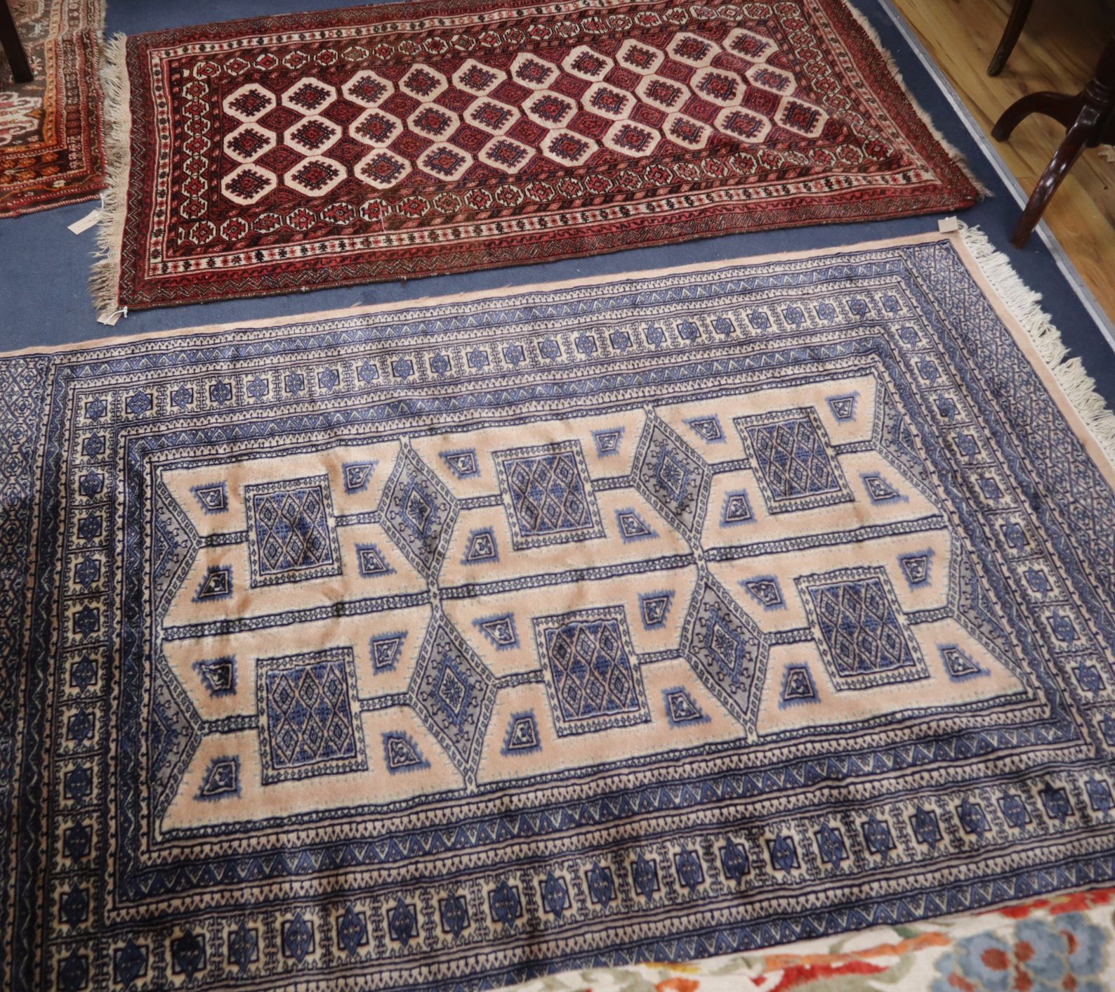 A Pakistan beige ground rug and a Belouchistan ivory ground rug Larger 190 x 130cm