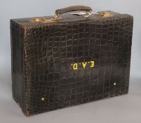 A George V crocodile skin toilet case with five silver mounted jars