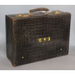 A George V crocodile skin toilet case with five silver mounted jars