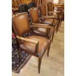 A set of four mid century beech elbow chairs