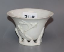 An 18th century Chinese blanc de chine 'prunus' libation cup