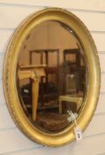 An oval gilt framed wall mirror H.60cm