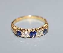A George V 18ct gold, two stone diamond and three stone sapphire half hoop ring, size K.