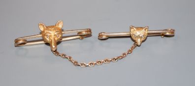 Two yellow metal foxhead tiepins, with diamond inset eyes, largest 37mm.