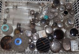A large quantity of assorted silver topped toilet jars, scent bottles etc. including tortoiseshell