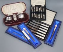A George V cased silver three piece condiment set, Birmingham, 1924 and five other plated cased