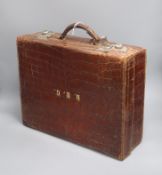 An early 20th century crocodile skin vanity case