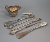 An Indian? white metal cream jug and other silver including salt spoon, fruit knife, button hooks,