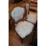 A pair of Louis XV style gilt salon chairs