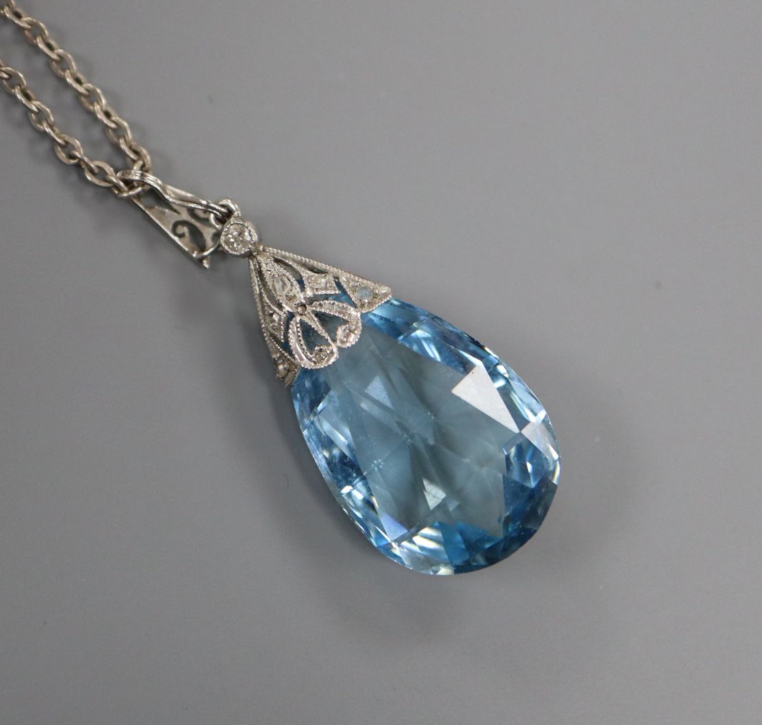 A white metal and teardrop-shaped aquamarine pendant with diamond-set suspension on sterling