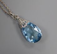 A white metal and teardrop-shaped aquamarine pendant with diamond-set suspension on sterling