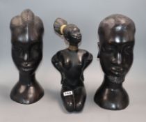 A pair of ebony carved Tribal busts and a pottery nude