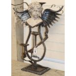 A wrought iron three branch candelabra with lyre shaped base, surmounted with reconstituted stone
