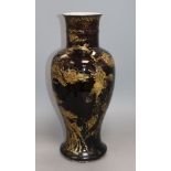 An 18th century Chinese gilt decorated mirror black glazed baluster vase, drilled hole