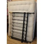 A Victorian iron and brass 4ft 6 inches bedframe with mattress