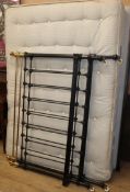 A Victorian iron and brass 4ft 6 inches bedframe with mattress