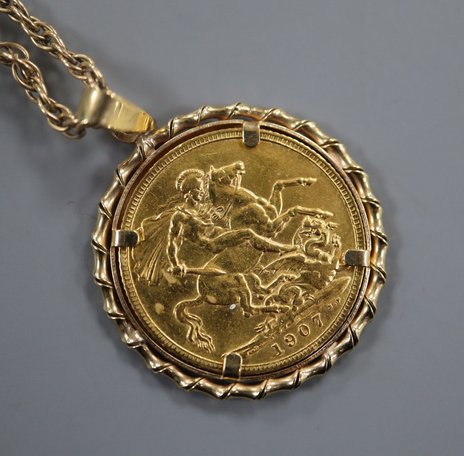 A gold full sovereign pendant, on 9ct chain.