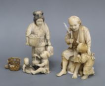 Two Japanese ivory okimono of figures with children, one signed to a red lacquer tablet, Meiji