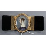A Victorian yellow metal mounted black sash bracelet, the central clasp with miniature oval portrait