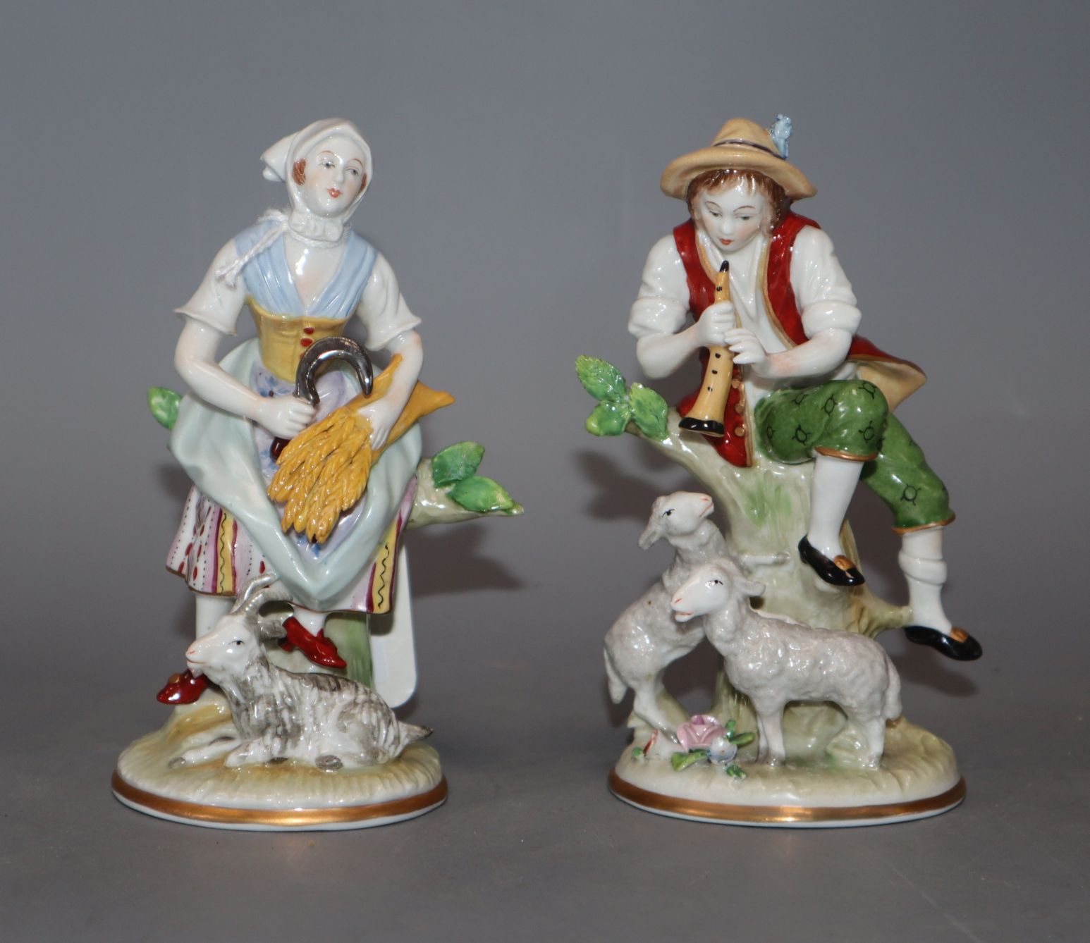 A pair of Sitzendorf porcelain figures of a shepherd and shepherdess, H 12cm