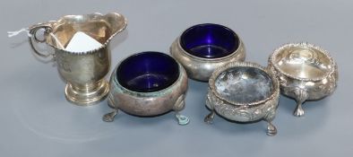 An Edwardian silver cream jug, London, 1909, a pair of Victorian silver bun slats and two other