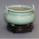 A Japanese celadon glazed tripod censer, wood stand Provenance - The owner and her family lived in