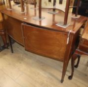 An Edwardian satinwood banded mahogany bow front sideboard W.122cm