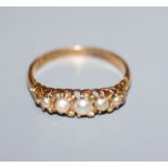 An early 20th century 18ct yellow metal and graduated split pearl set half hoop ring, size M.
