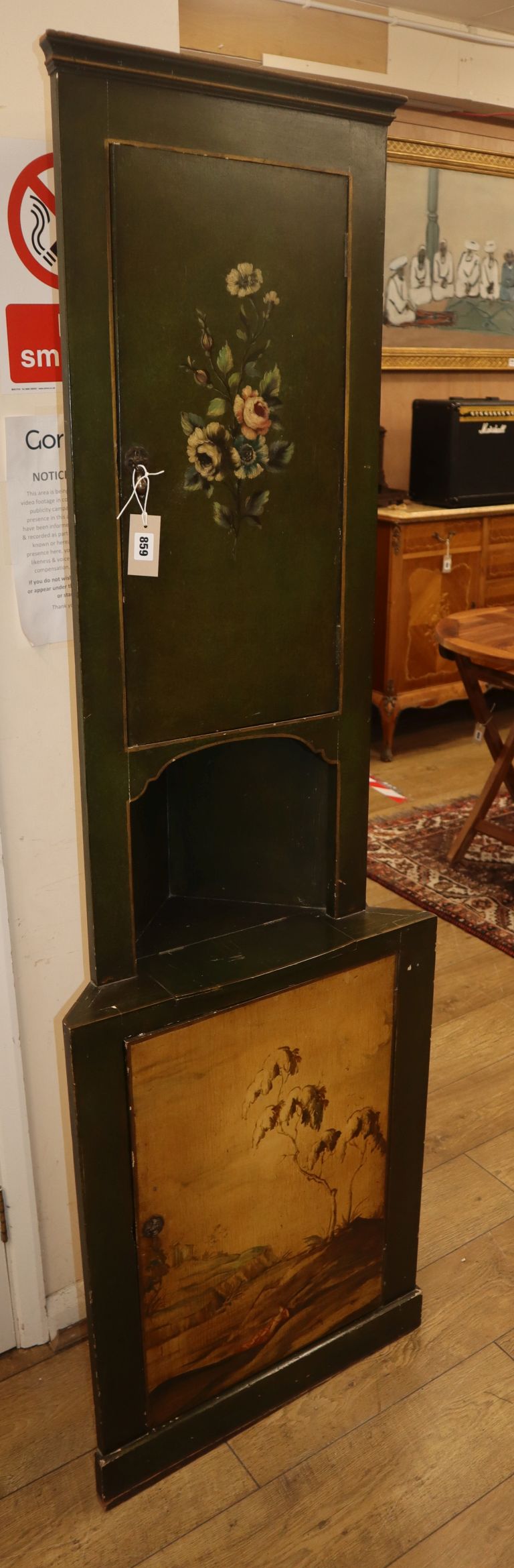 A polychrome decorated green painted standing corner cupboard H.182cm