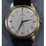 A gentleman's yellow metal Omega manual wind wrist watch, with case back inscription.