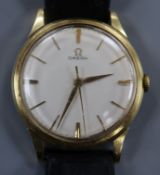 A gentleman's yellow metal Omega manual wind wrist watch, with case back inscription.