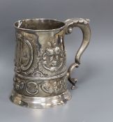 A late George II silver mug, with later embossed decoration, London, 1757 (a.f.), 12.9cm, 14.5 oz.