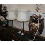 Two ceramic table lamps and shades and a pair of lamps