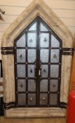 A Gothic style wrought iron framed window with heavy reconstituted stone frame H.160cm