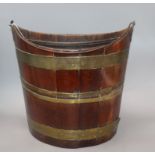 An early 19th century mahogany triple brass bound oyster bucket height 37cm
