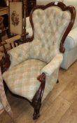 A Victorian carved mahogany framed spoonback buttoned back armchair