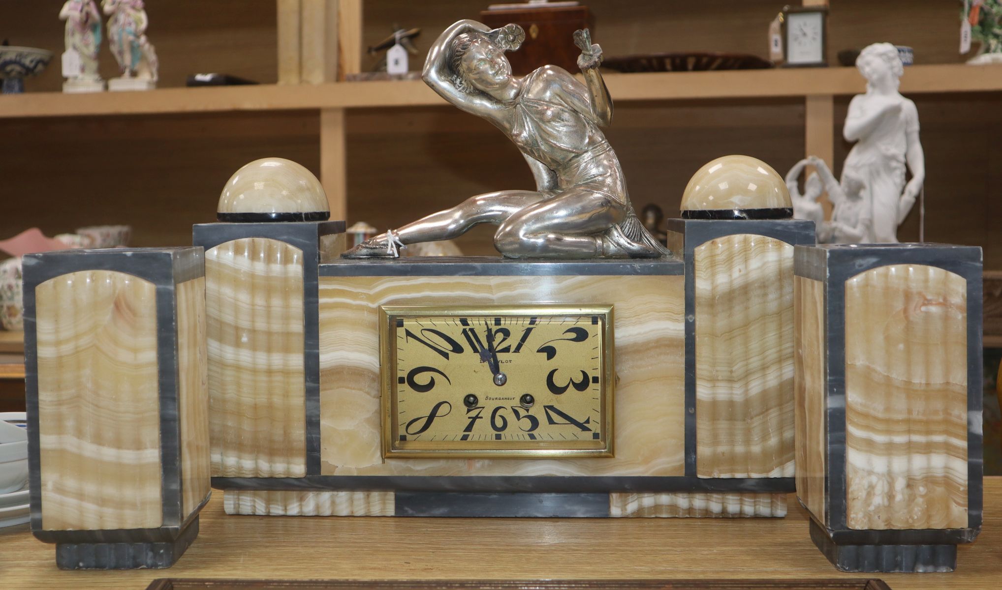 An Art Deco grey and cream marble clock garniture, with figural surmount height 34.5cm
