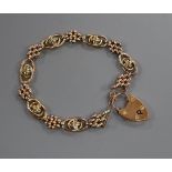 An Edwardian 9ct and seed pearl set fancy link bracelet (pearls missing), gross 12 grams.