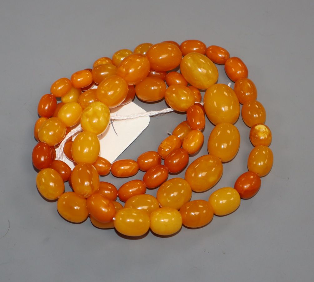 A single strand graduated oval amber bead necklace, gross weight 69 grams, 88cm.