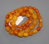 A single strand graduated oval amber bead necklace, gross weight 69 grams, 88cm.