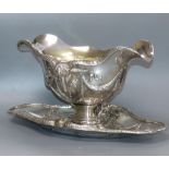 An ornate 800 standard white metal double lipped sauceboat dish, with ram's head and swag