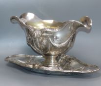 An ornate 800 standard white metal double lipped sauceboat dish, with ram's head and swag