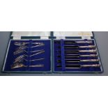 A cased set of six silver handled dessert knives and a cased set of six silver pastry forks.