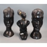 A pair of ebony carved Tribal busts and a pottery nude